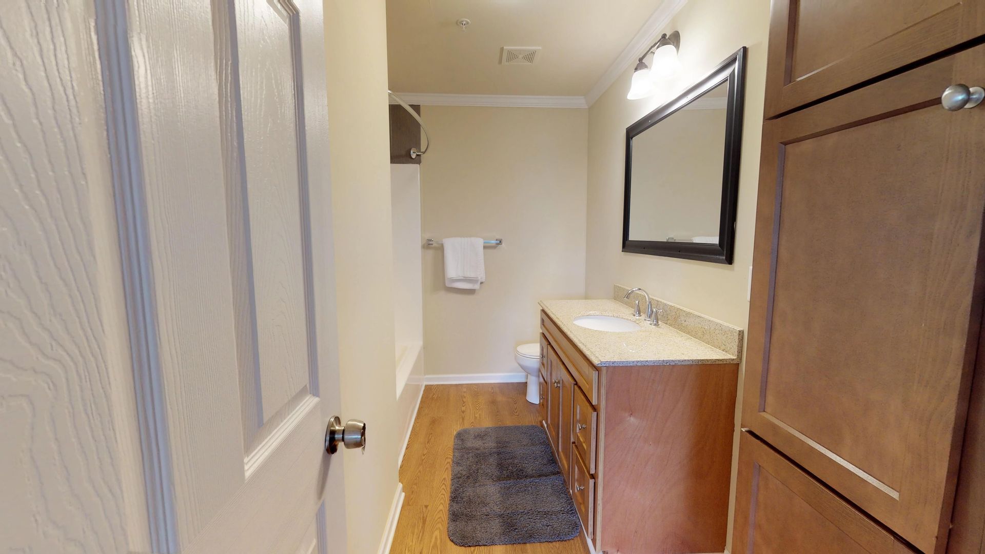 A bathroom with a sink , toilet and mirror.