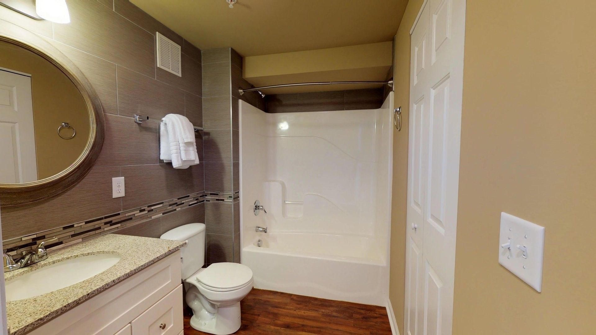 A bathroom with a toilet , sink , and bathtub.