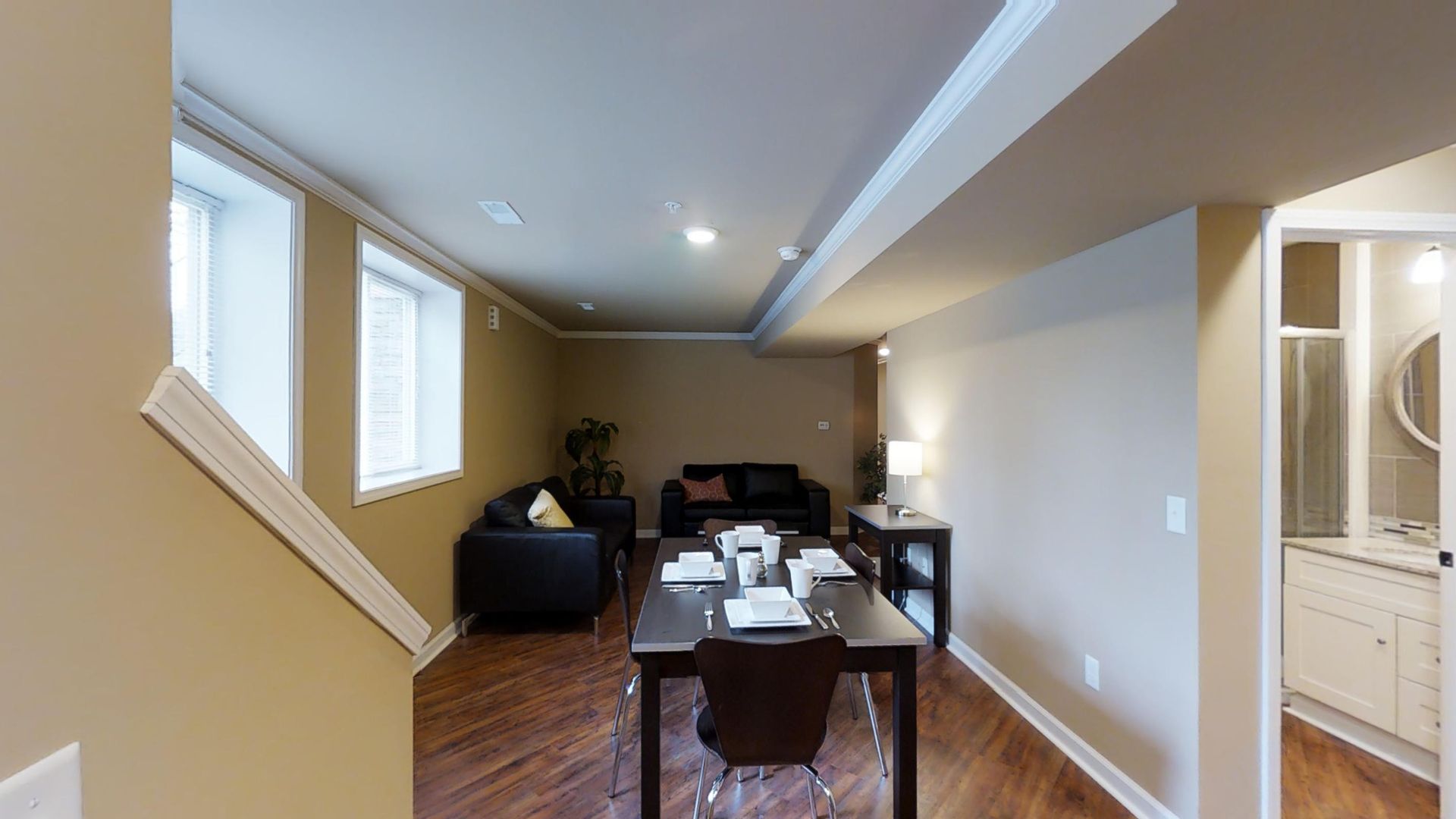 A living room with a dining table and chairs and a couch.