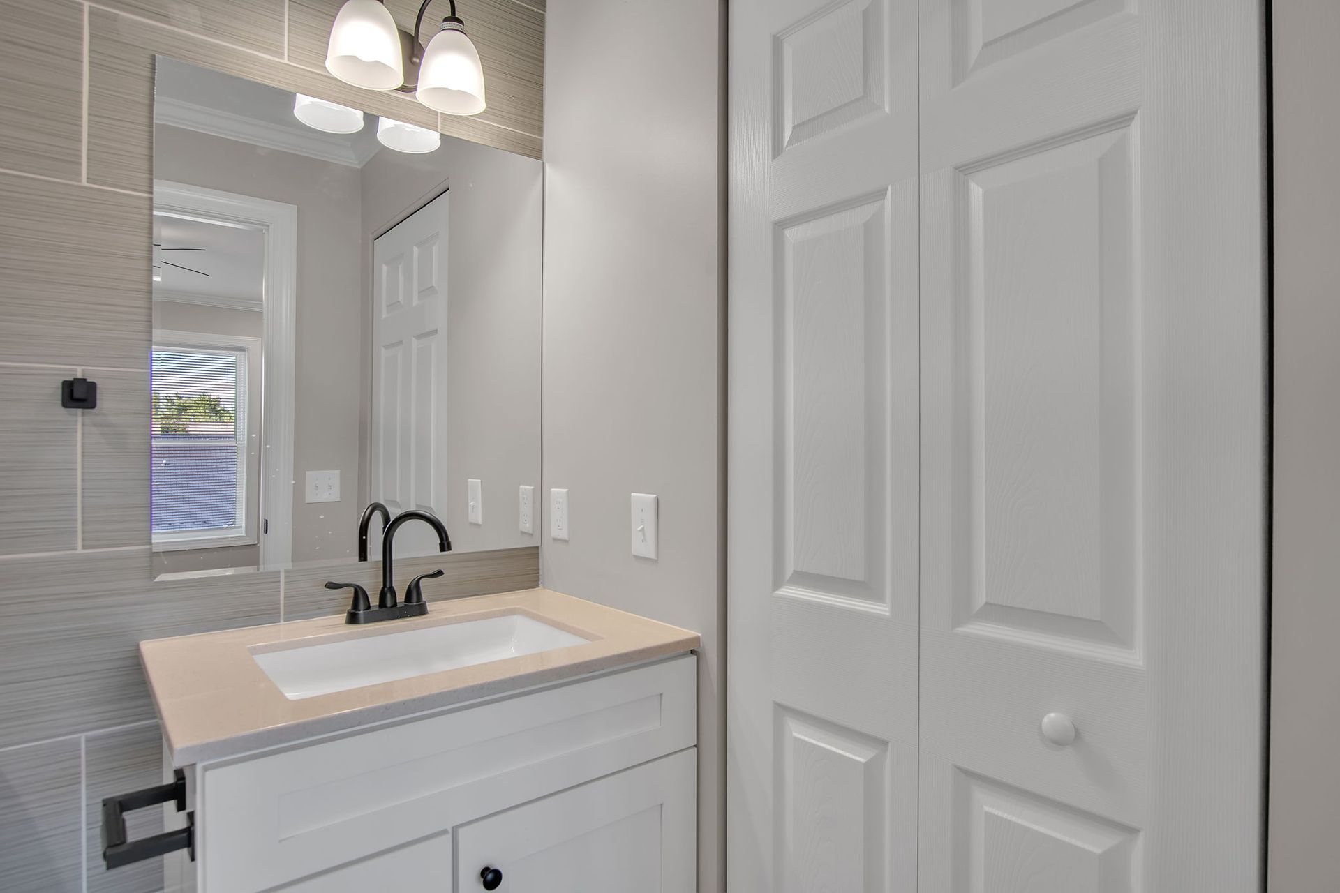 Wash area with modern sink installation and clean tile wall