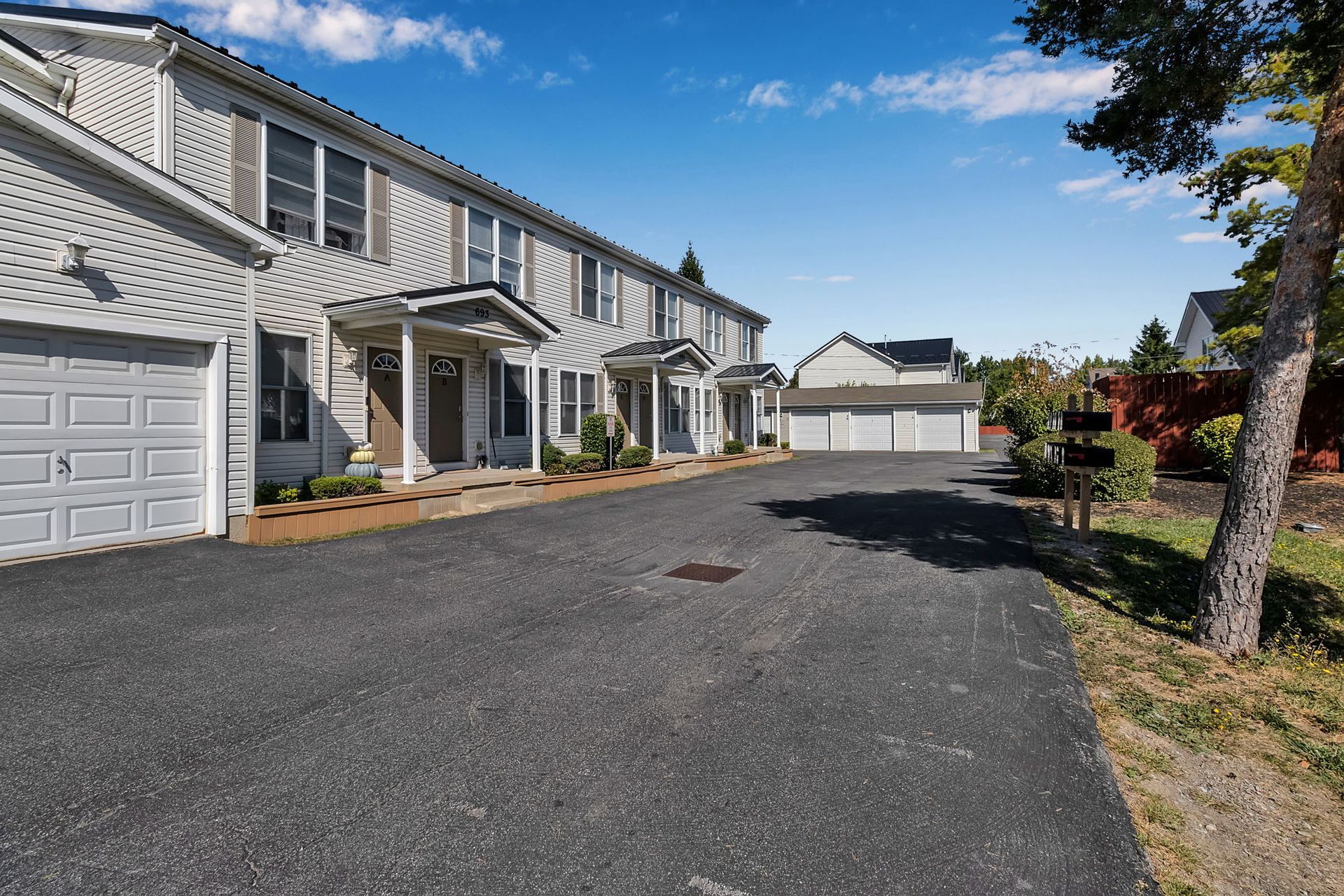 Exterior perspective of apartment homes with tree-lined surroundings