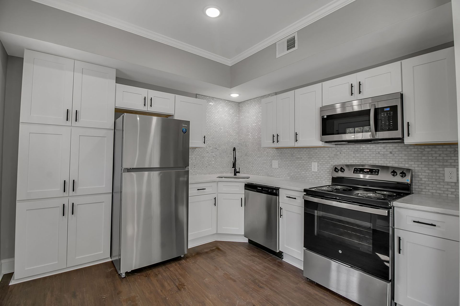 Kitchen area with contemporary cabinet installation and workspace