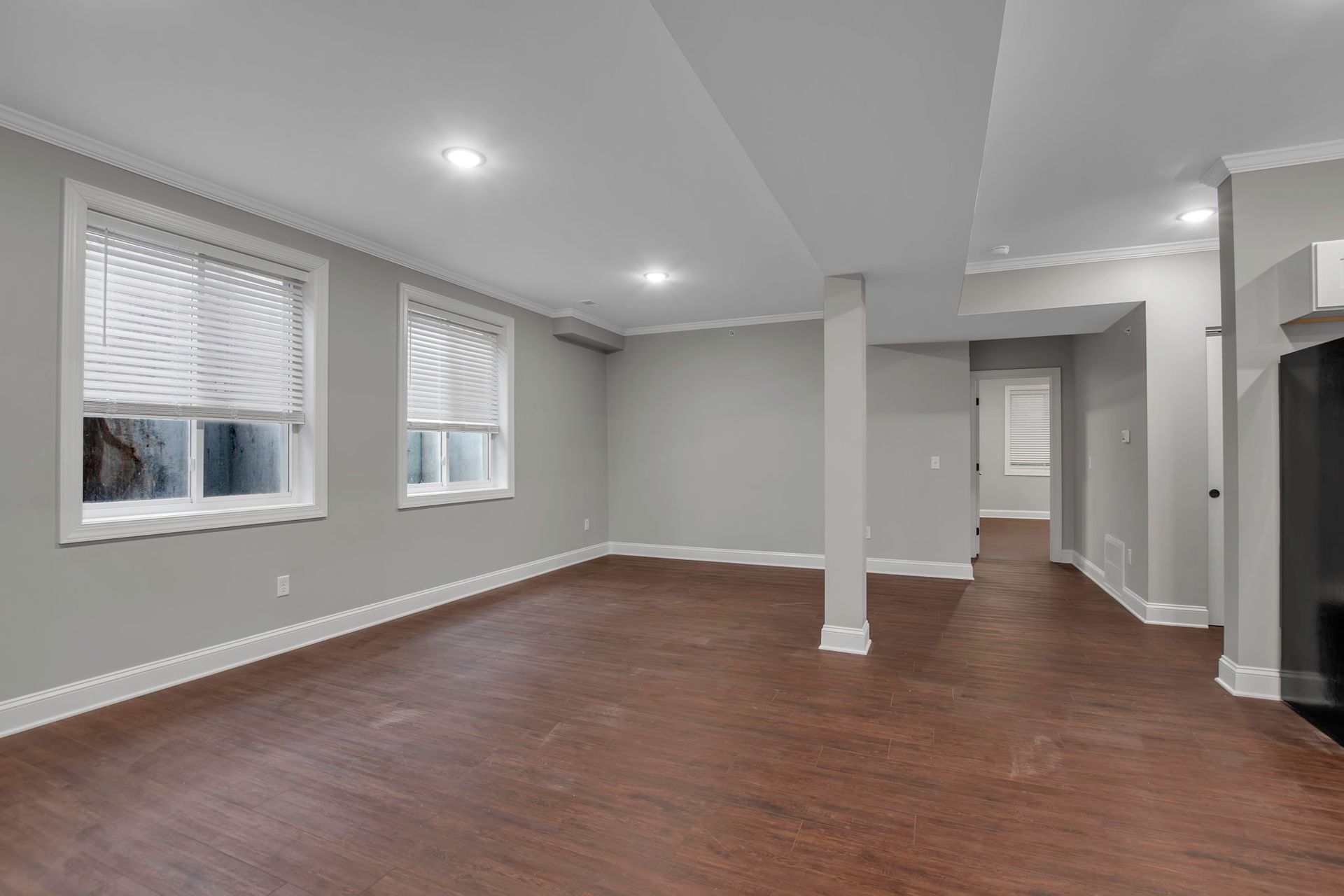 Lounge area inside apartment with polished flooring and trim accents