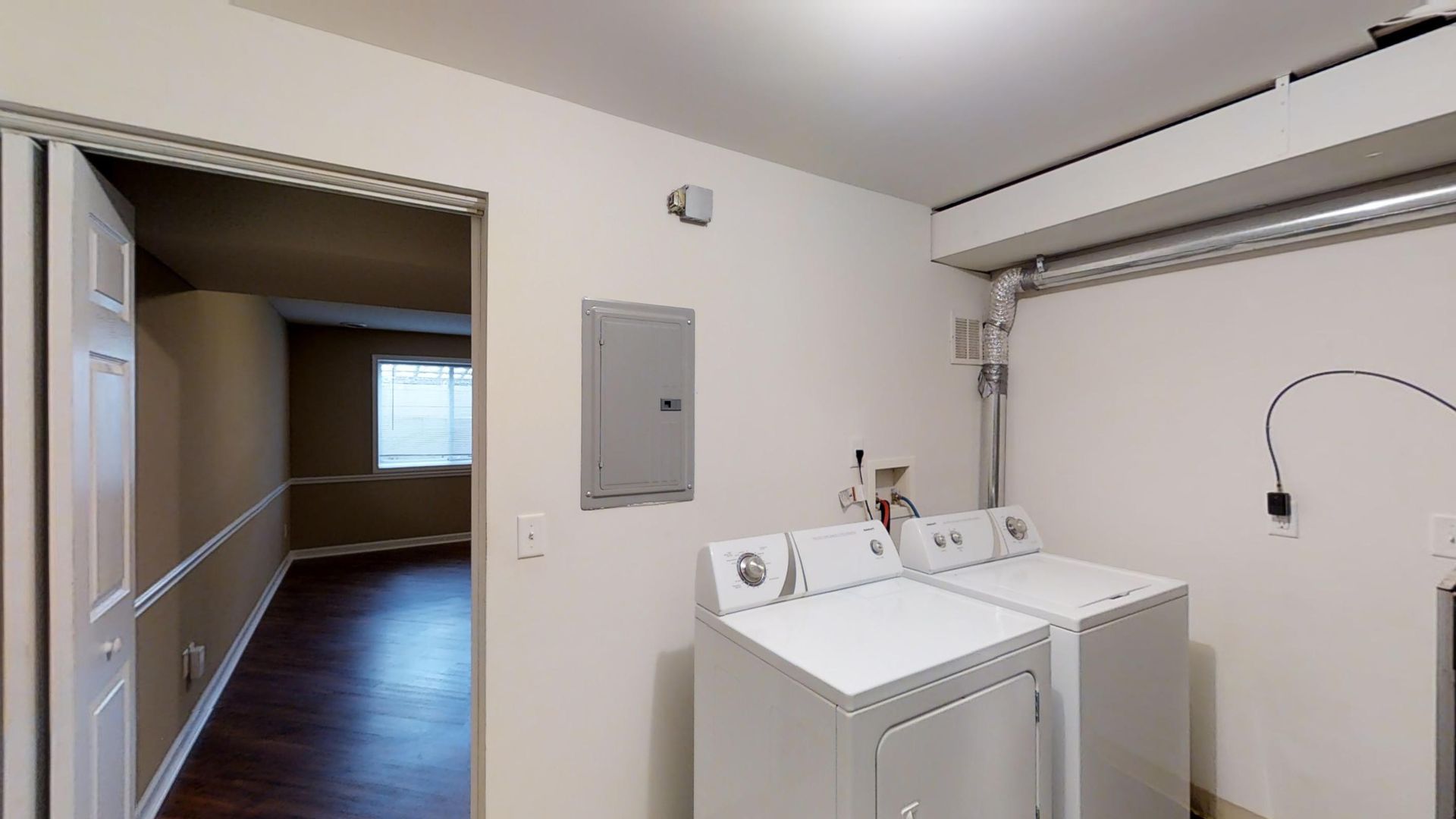 A laundry room with a washer and dryer in it.