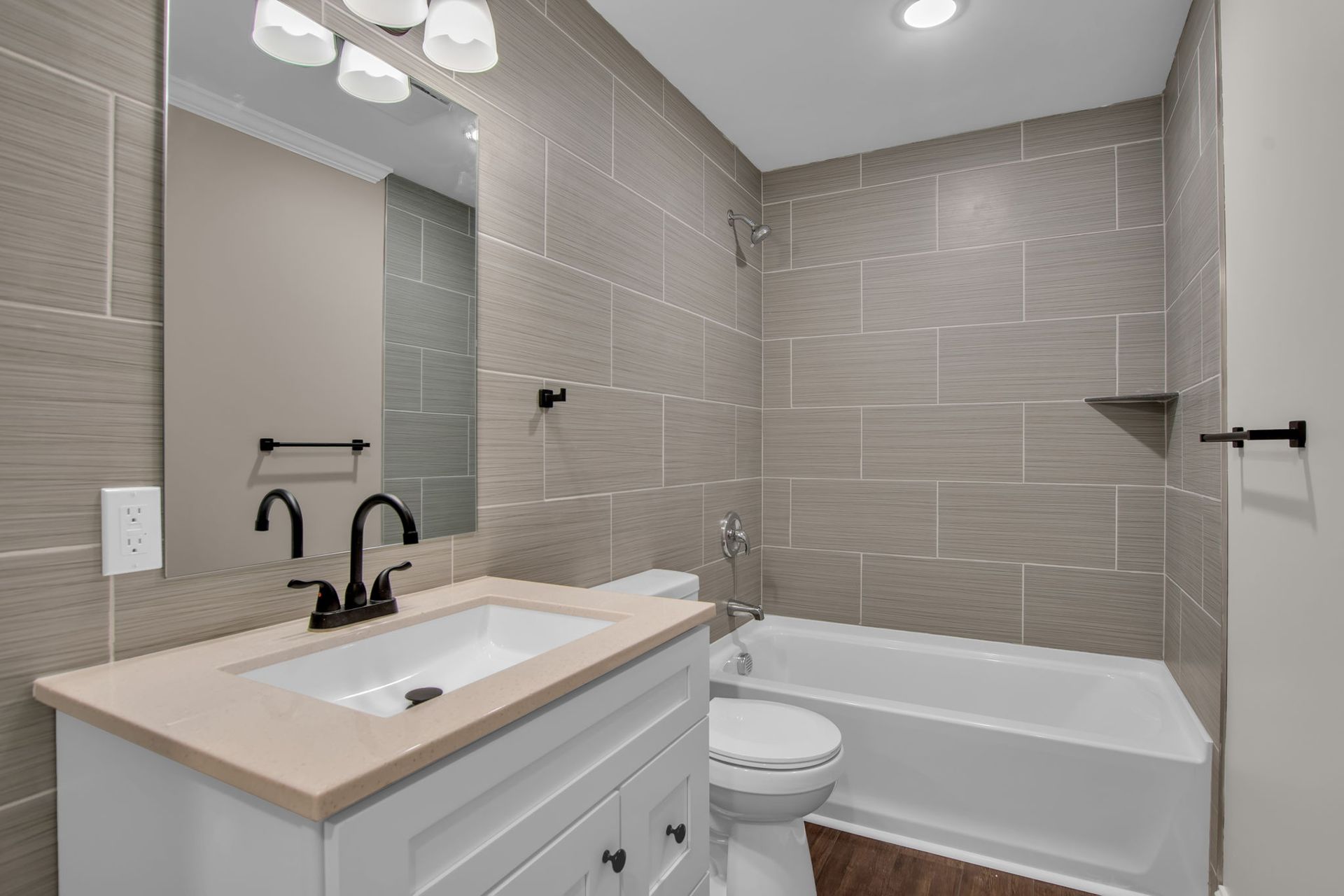 Updated bathroom with tiled shower and bathtub