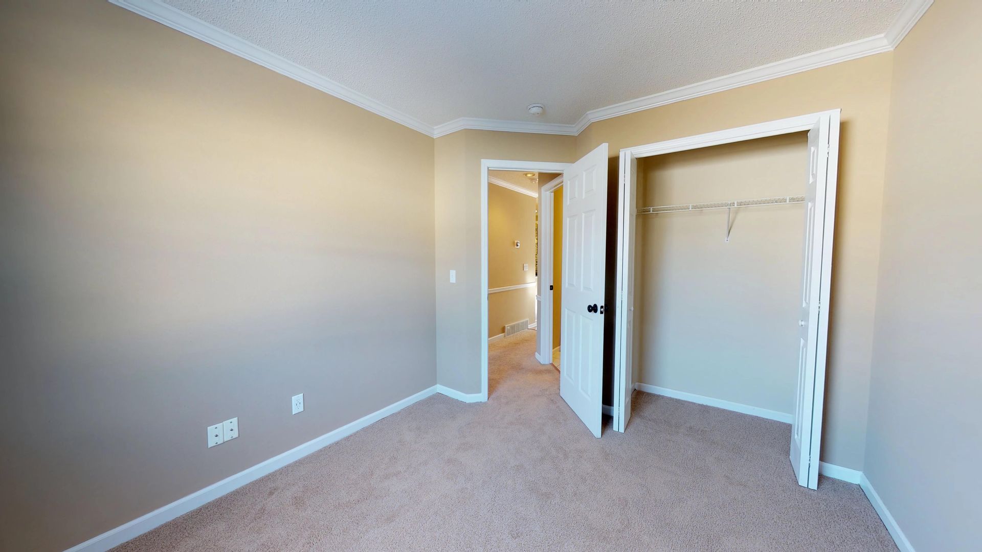 An empty bedroom with a closet and a walk in closet.