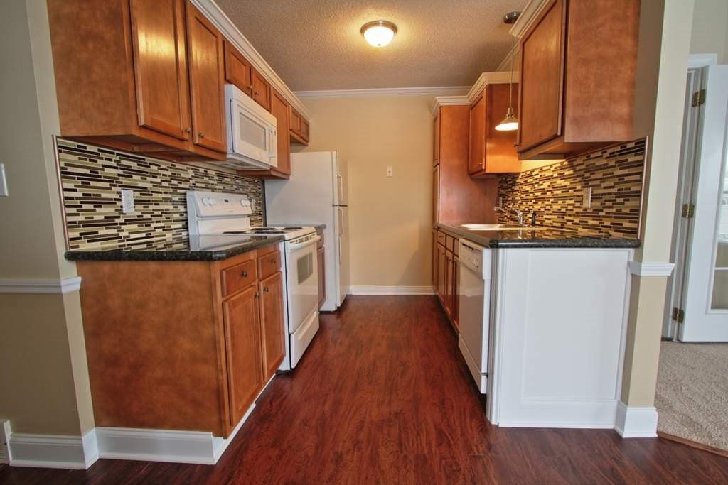 A kitchen with wooden cabinets and stainless steel appliances