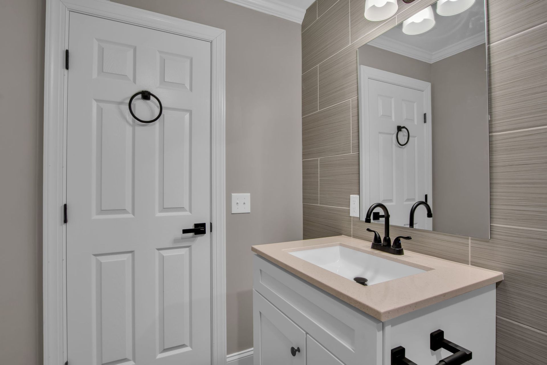 Modern apartment bathroom with vanity sink and mirror lighting
