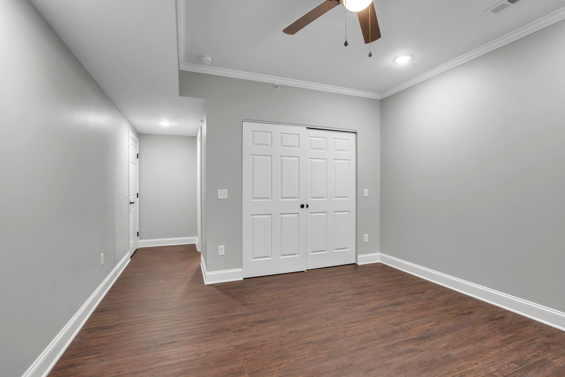 Apartment sleeping area with polished floor surface and trim