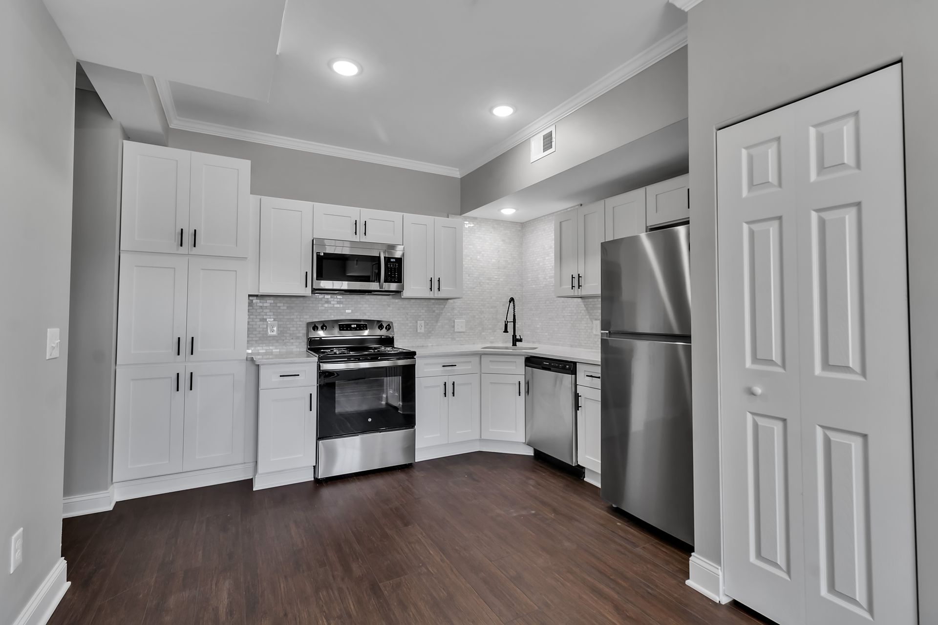 Apartment cooking space with modern cabinet storage