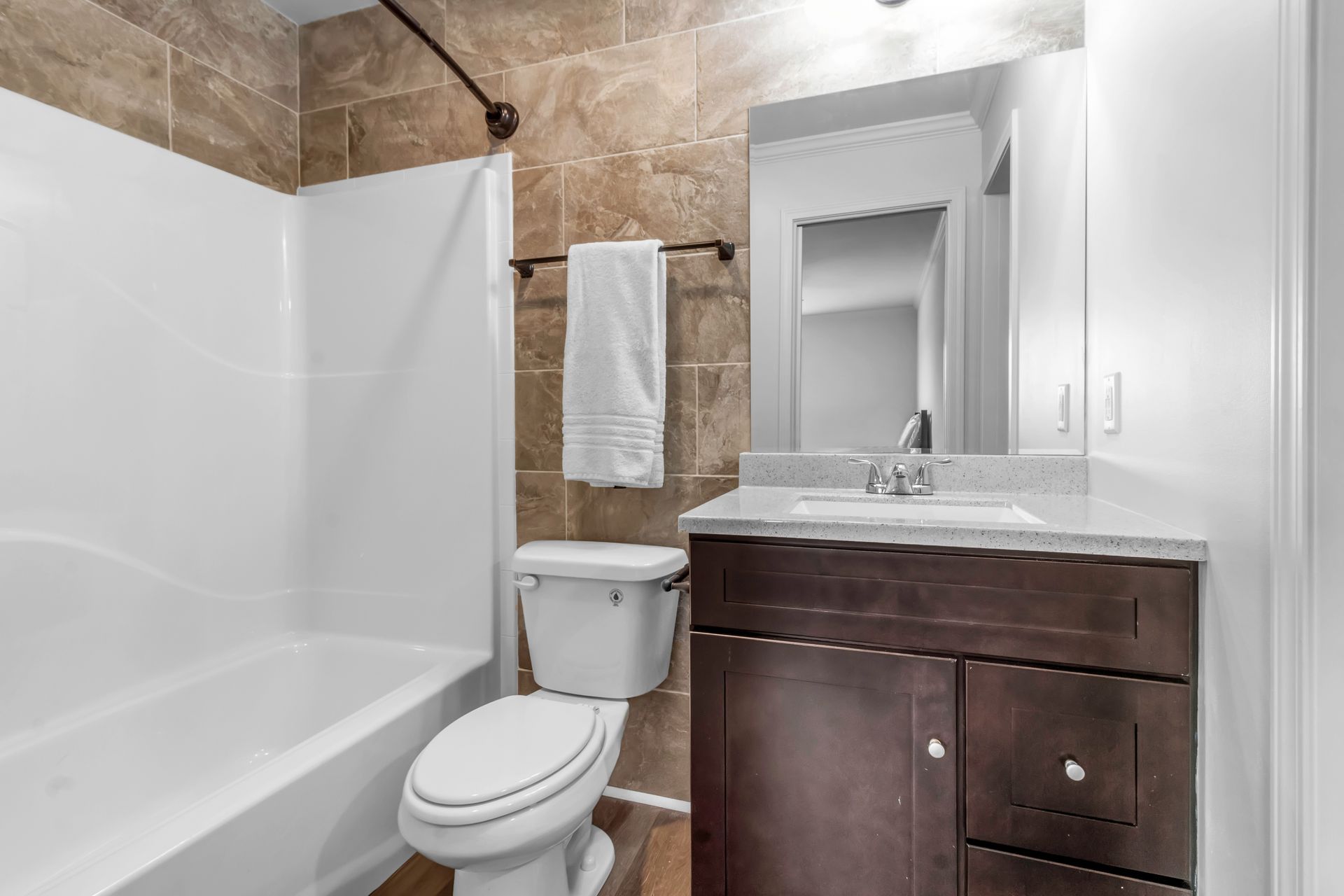 A bathroom with a toilet , sink , and bathtub.