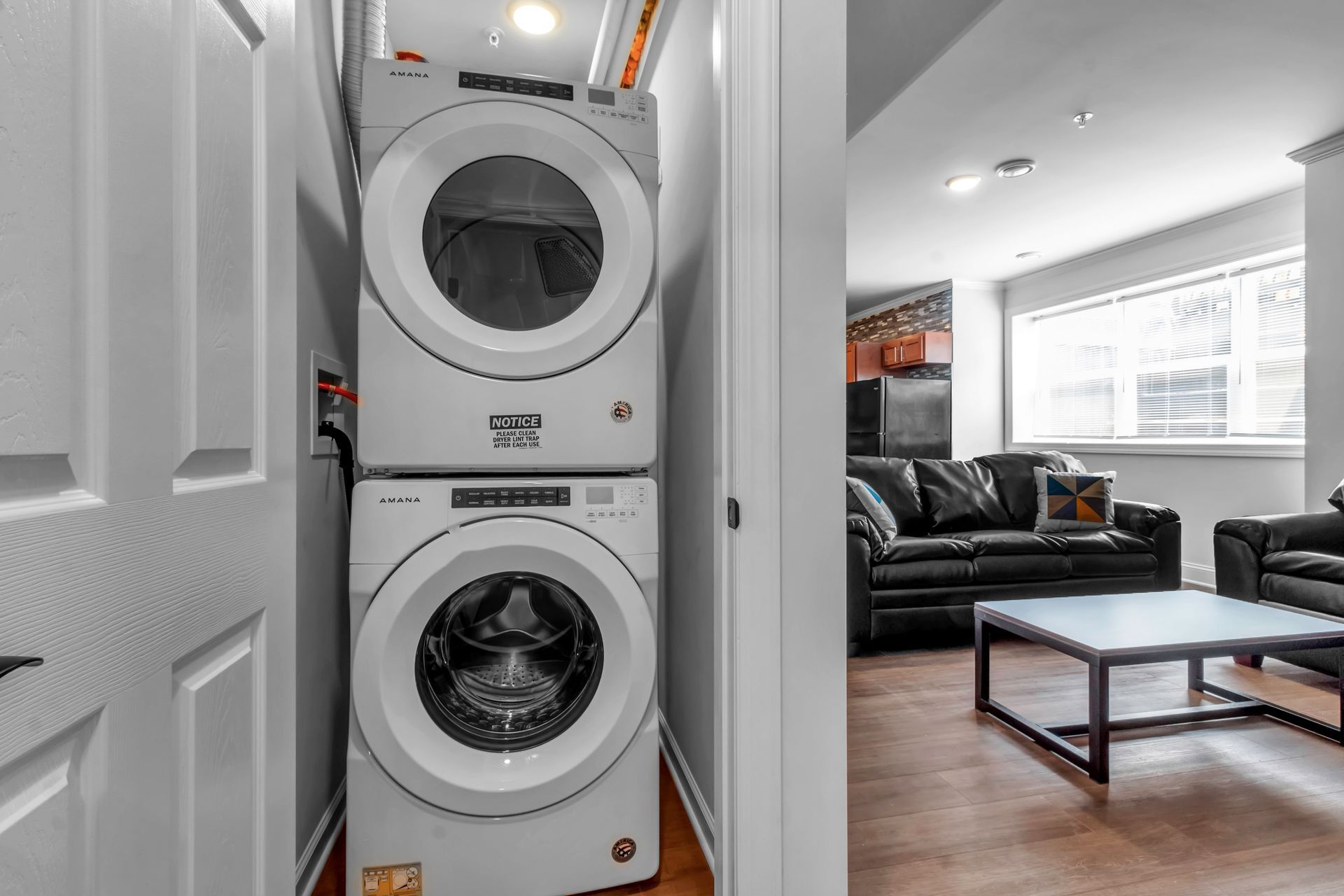 A washer and dryer are stacked on top of each other in a laundry room.