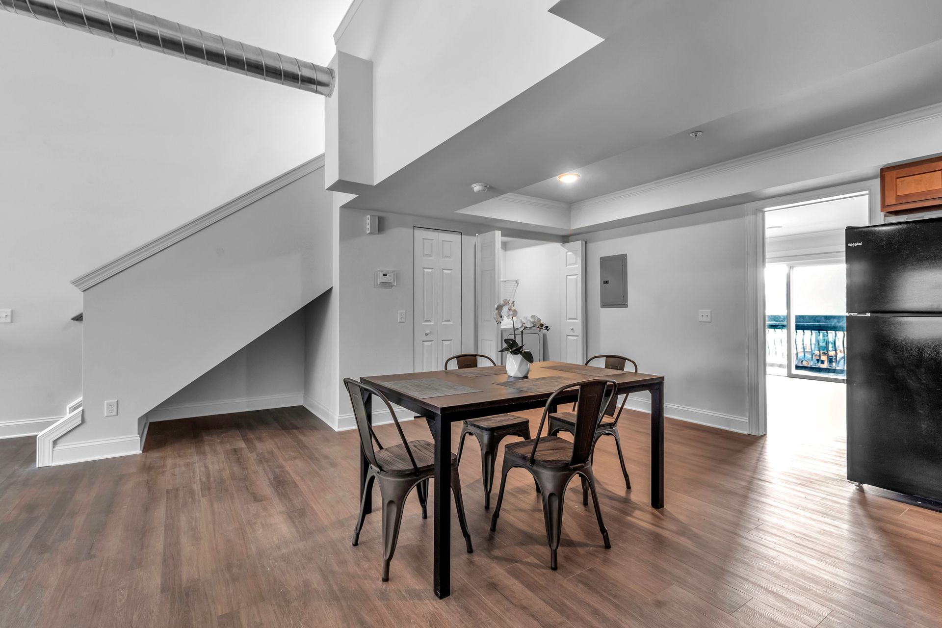 There is a table and chairs in the middle of the room.