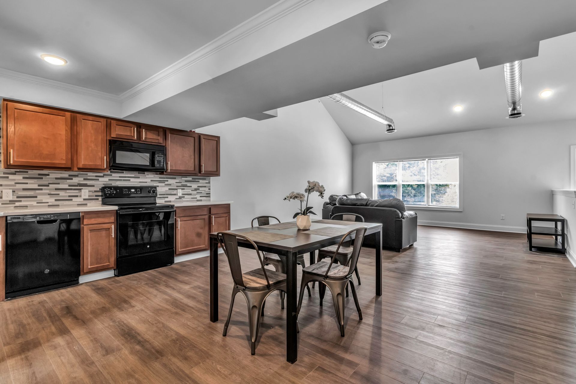 A kitchen with a dining table and chairs in it.