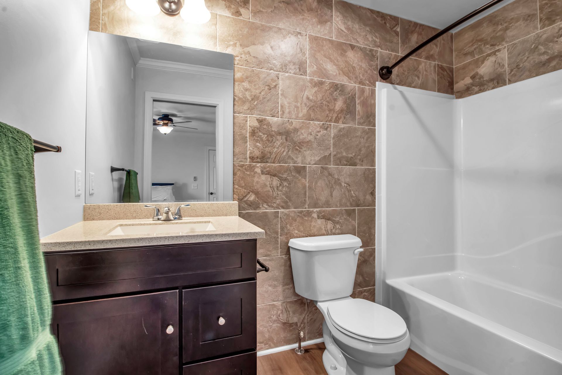 A bathroom with a toilet , sink , and bathtub.