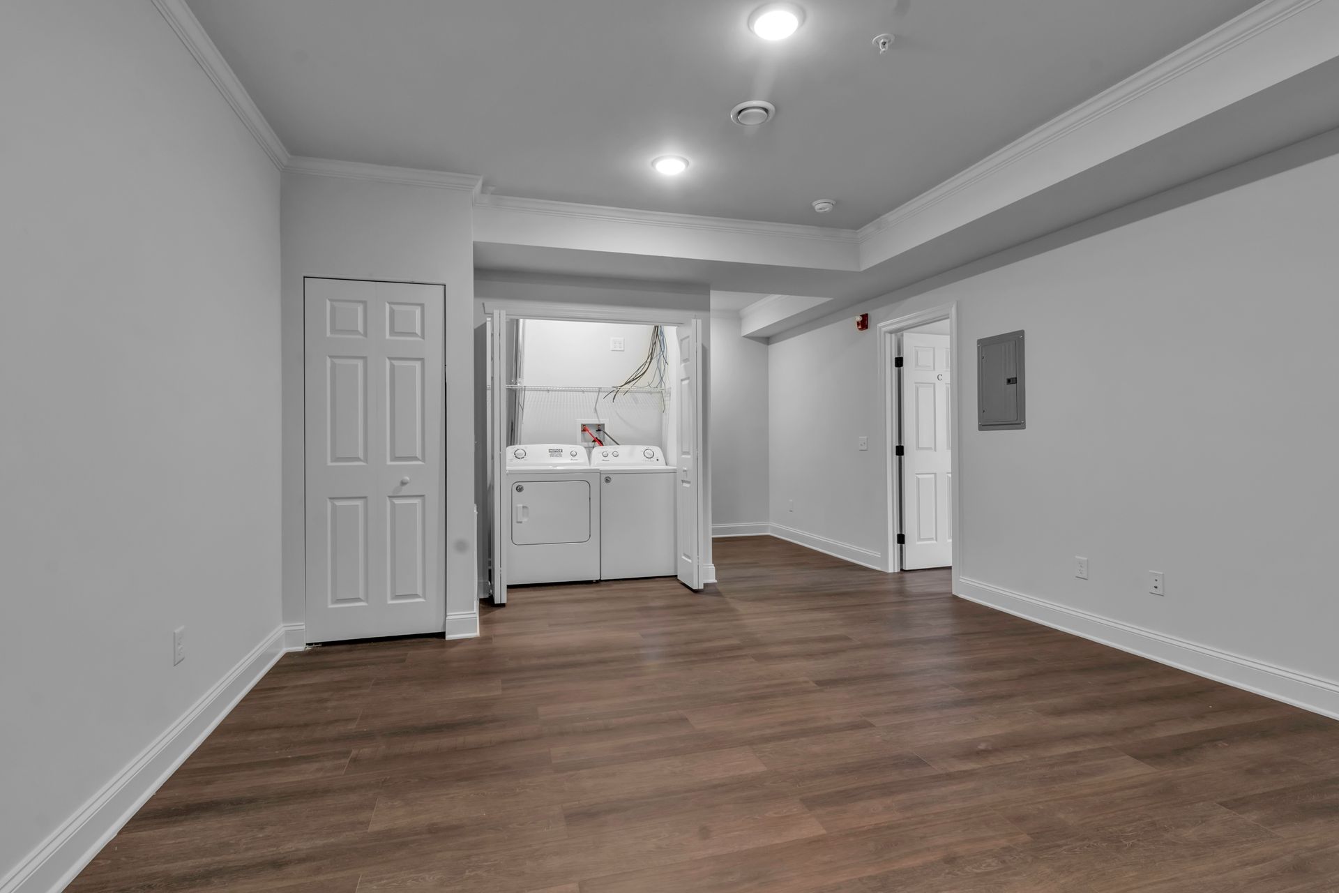 An empty room with a washer and dryer in it.