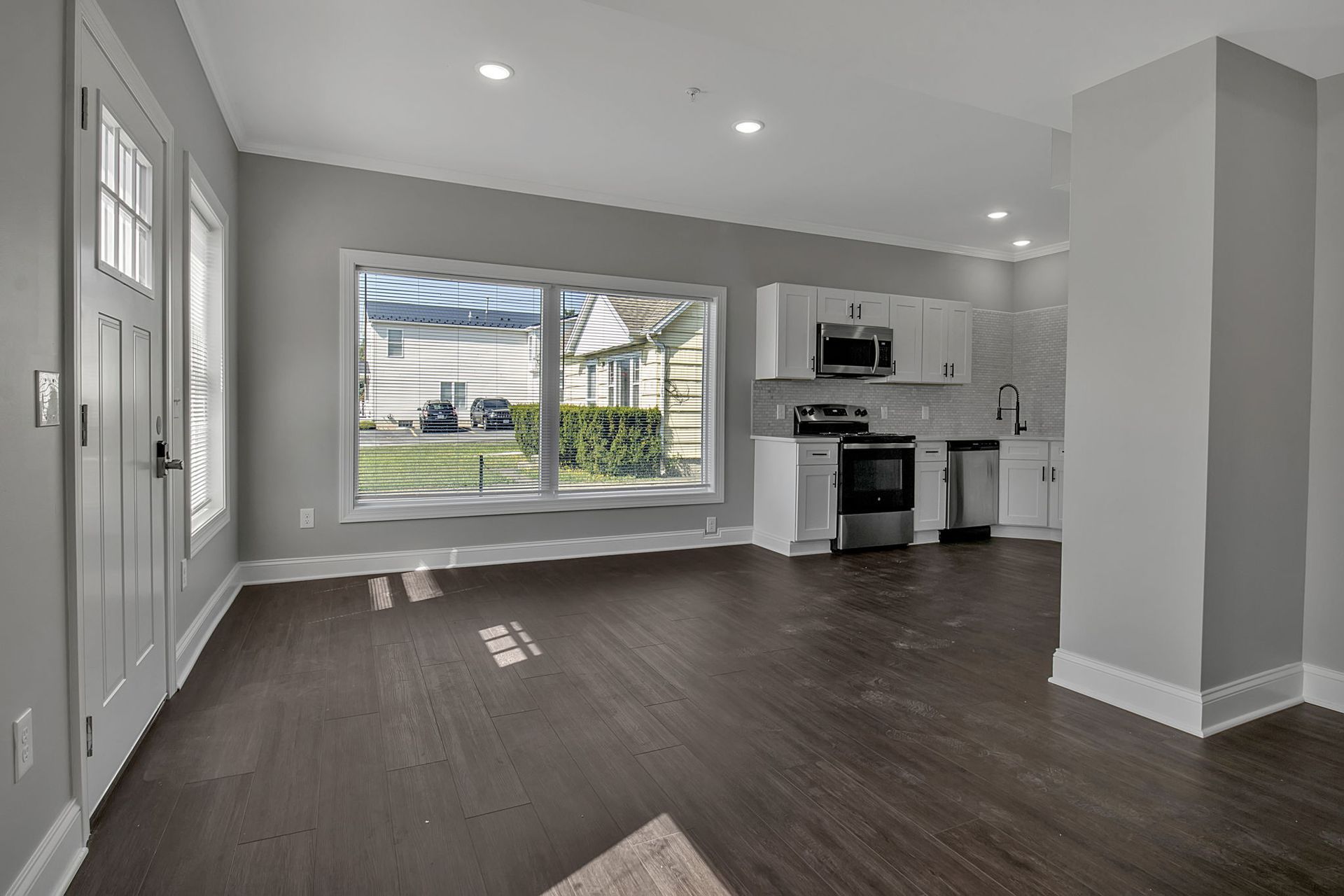 Bright living area with wood-style flooring and modern trim