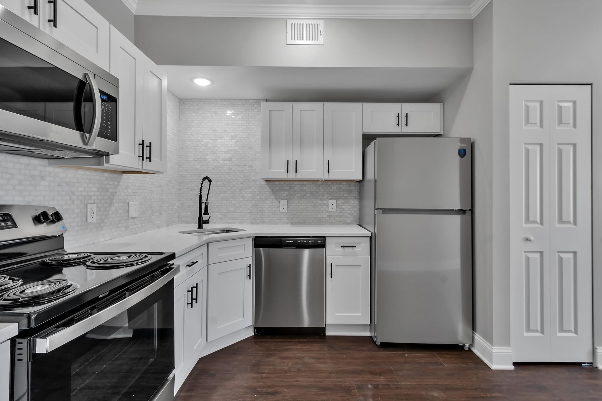 Residential kitchen interior featuring sleek cabinet construction