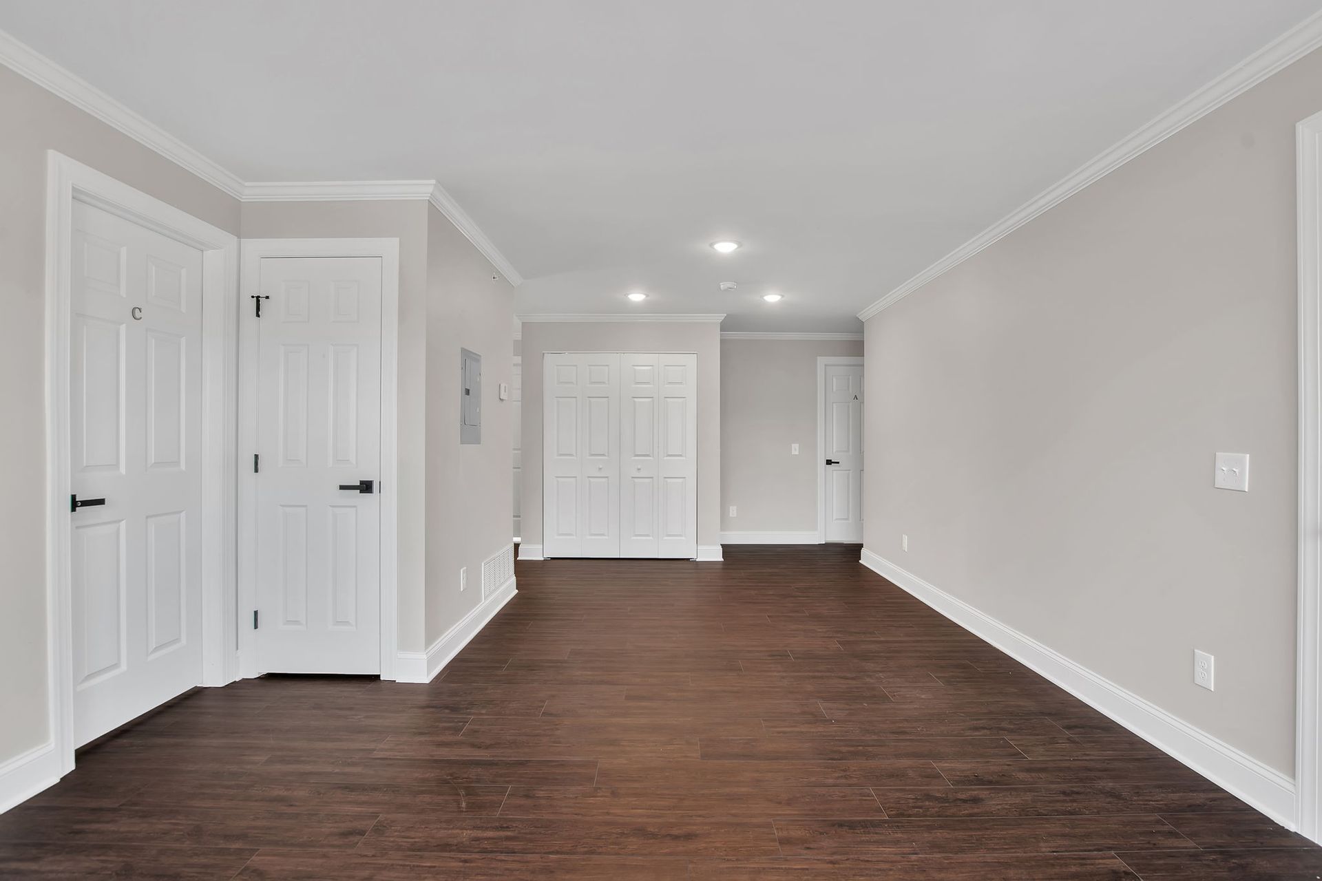 Apartment lounge space with clean flooring and neutral palette