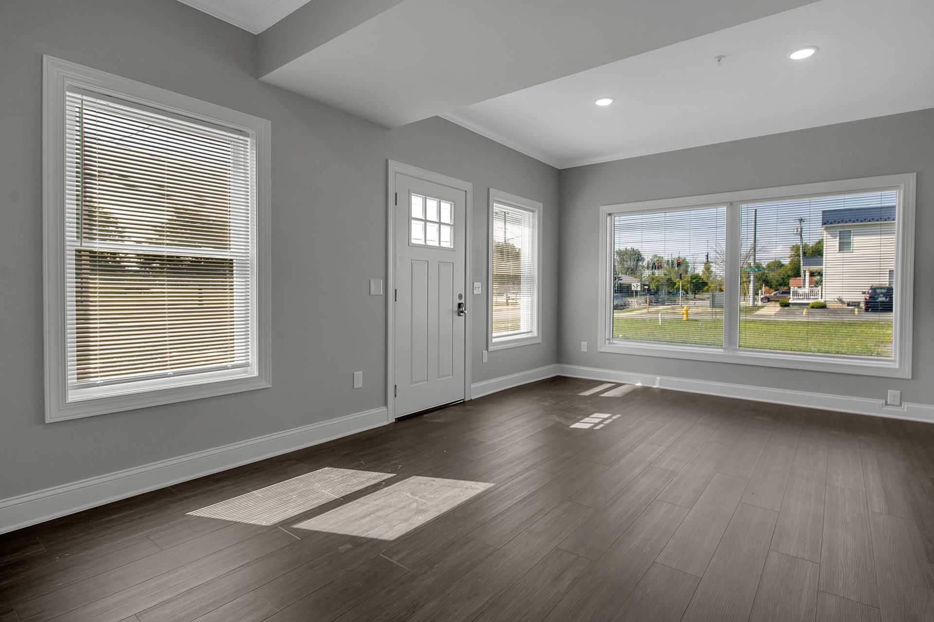 Bright living area with wood-style flooring and modern trim