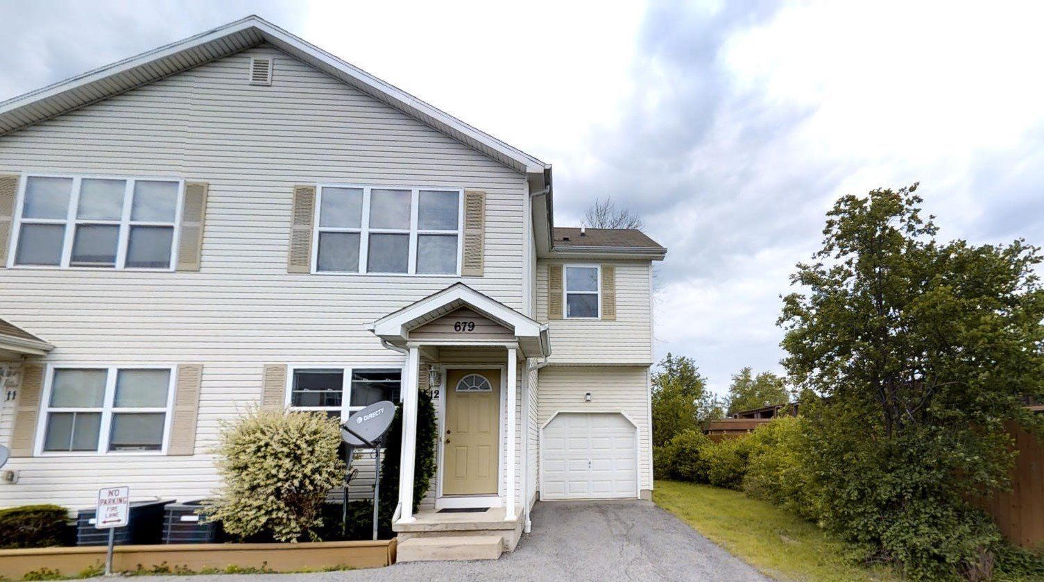 A large white house with a garage and a driveway