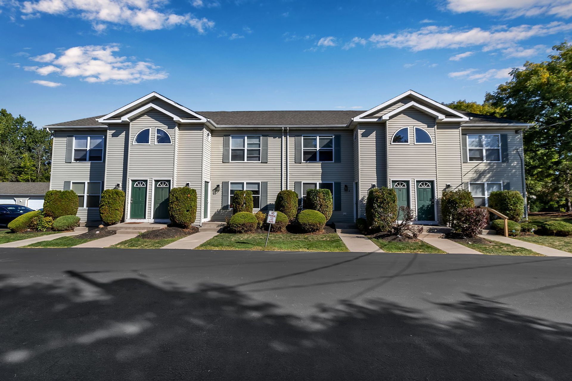 Townhome-style apartment building with private entrances and landscaping at a Wyse Properties community in Amherst NY