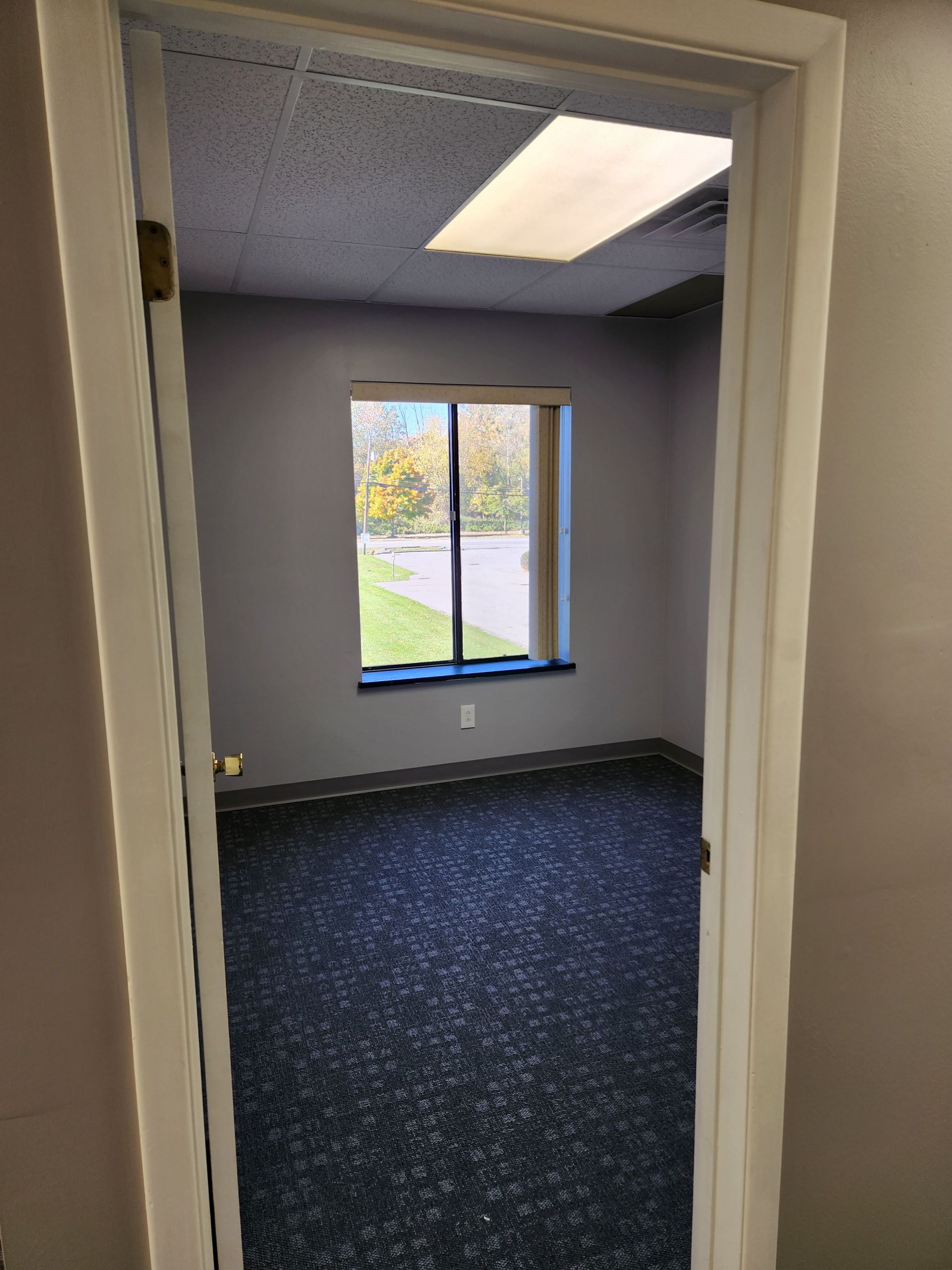 A doorway leading into an empty room with a window.