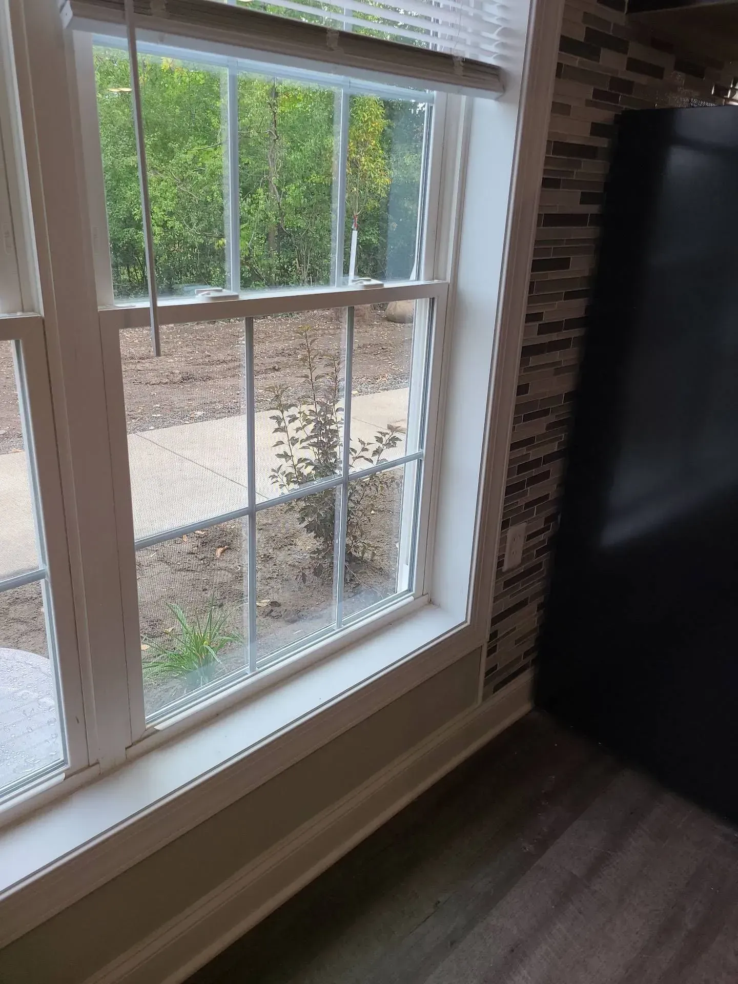 A window in a room with a brick wall behind it
