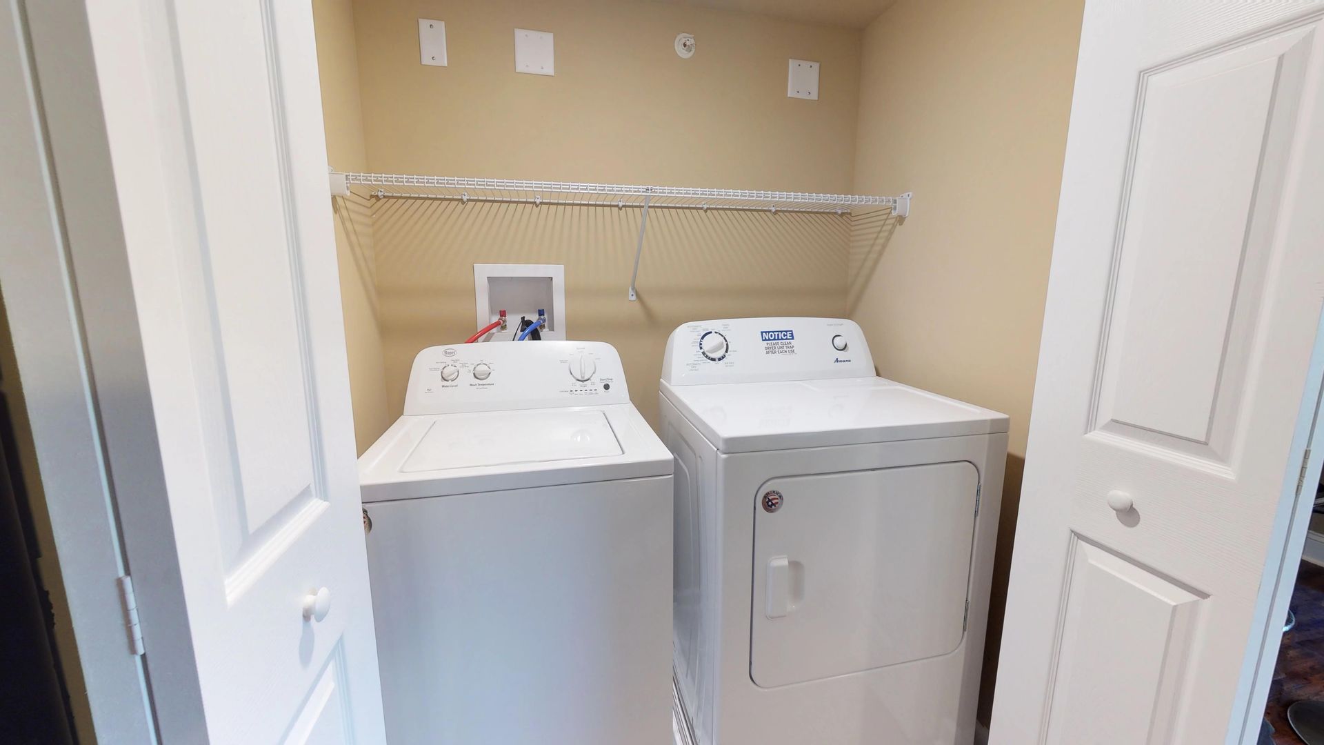 A laundry room with a washer and dryer in it.