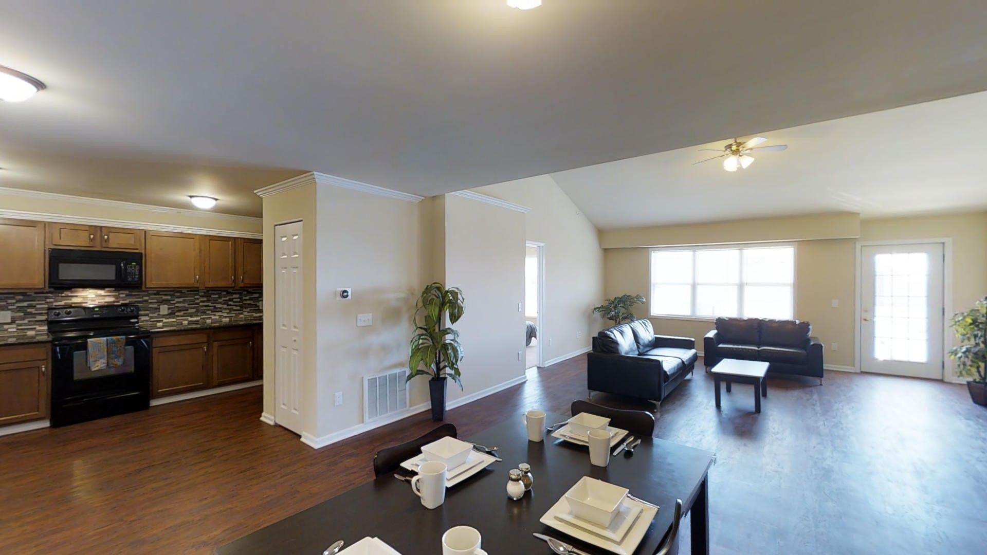 A living room with a dining table and a couch