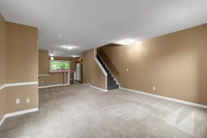 Apartment sitting room featuring subtle lighting and open space