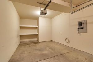Single-car garage interior with overhead door and concrete floor