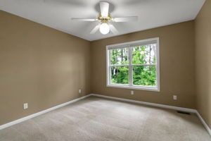 Apartment bedroom with ceiling fan and neutral wall colors