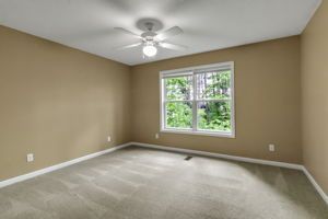 Spacious apartment bedroom with wide window and trim detail
