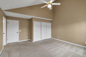 Large bedroom with closet storage and neutral walls