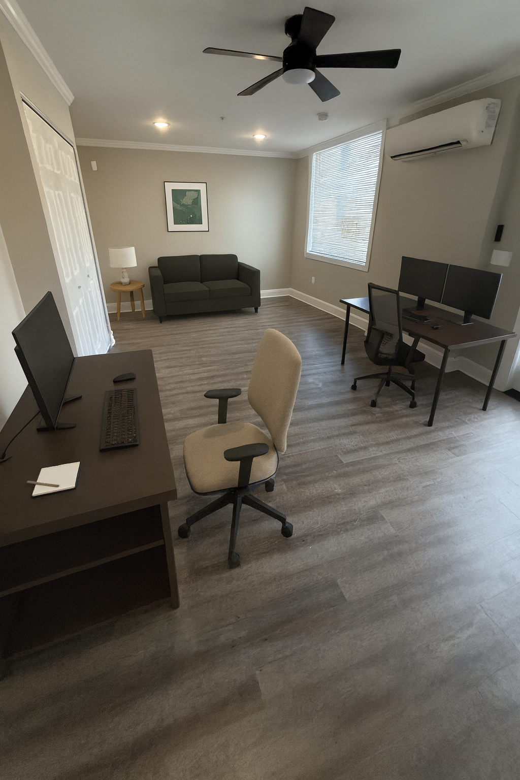 Apartment living area with open layout and smooth flooring finish