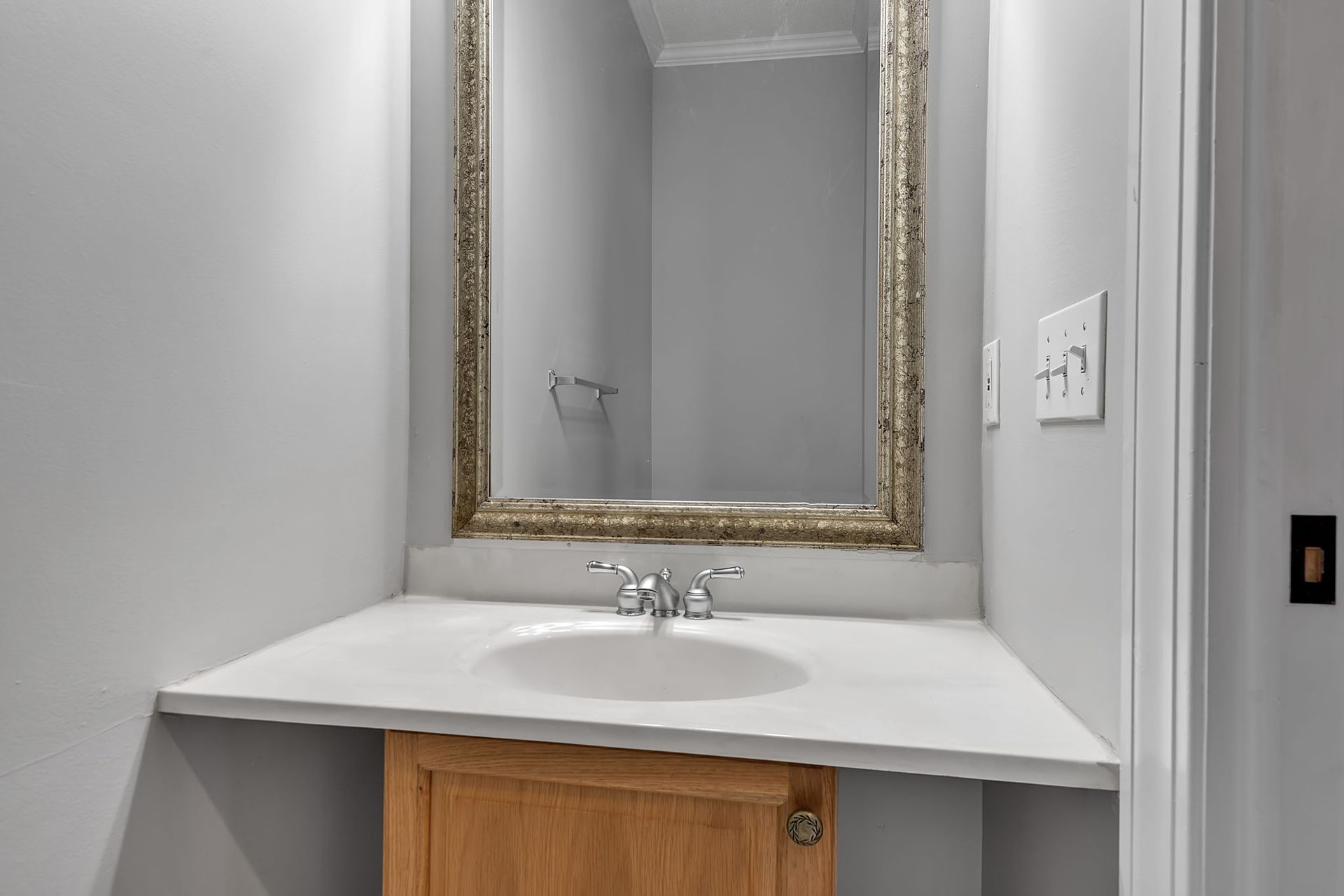 Apartment bathroom with tiled shower wall and bathtub