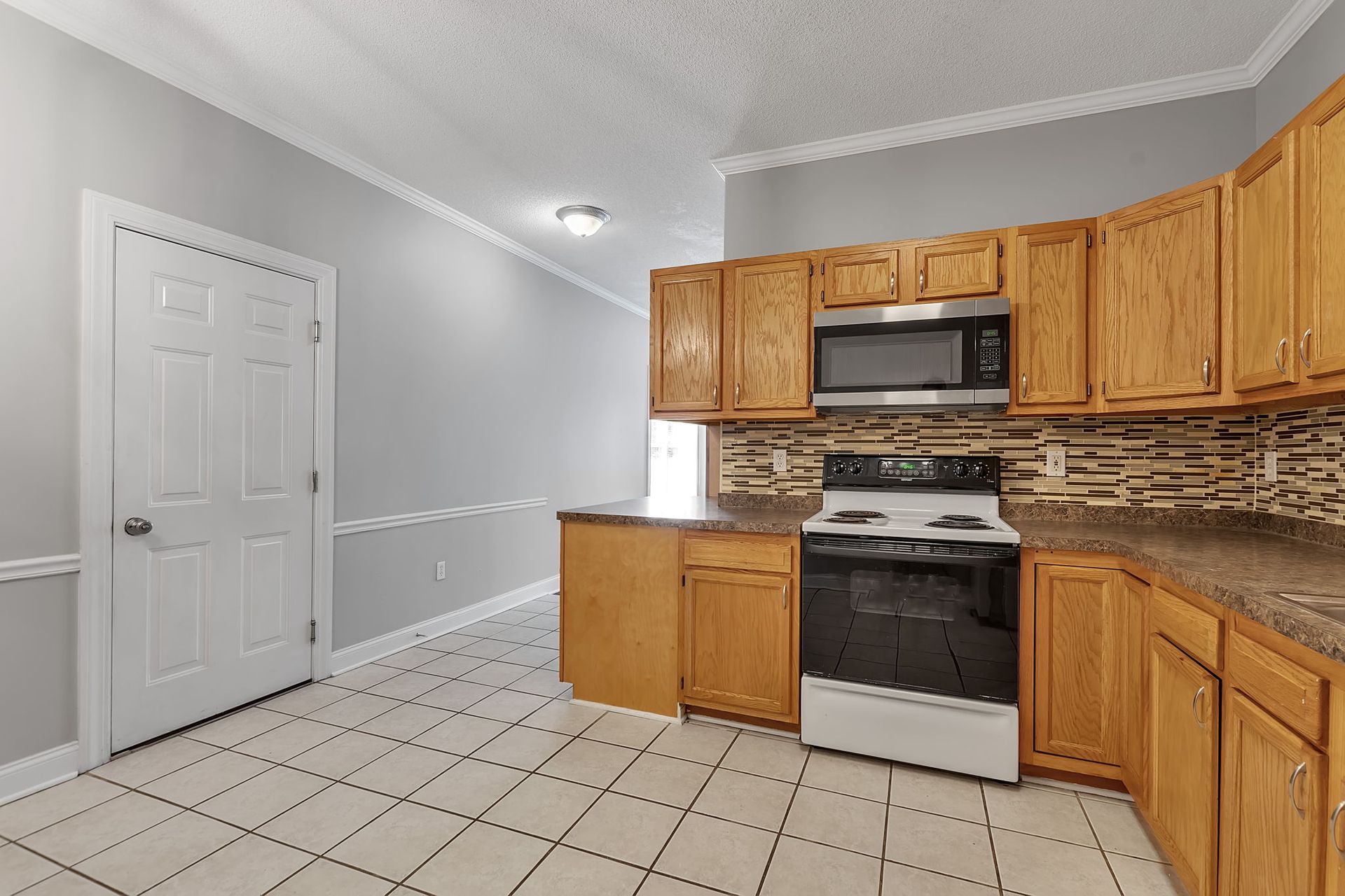 Residential kitchen area featuring sleek countertop surfaces