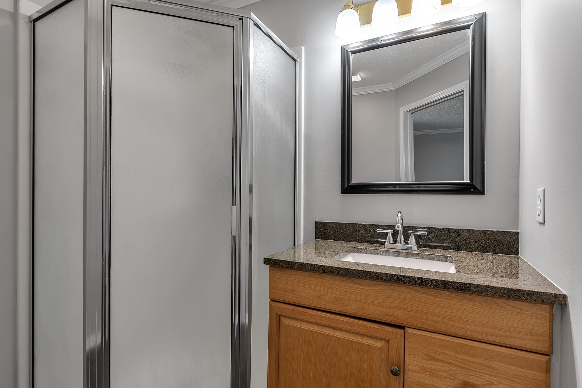 Bathroom vanity with sink and mirror lighting