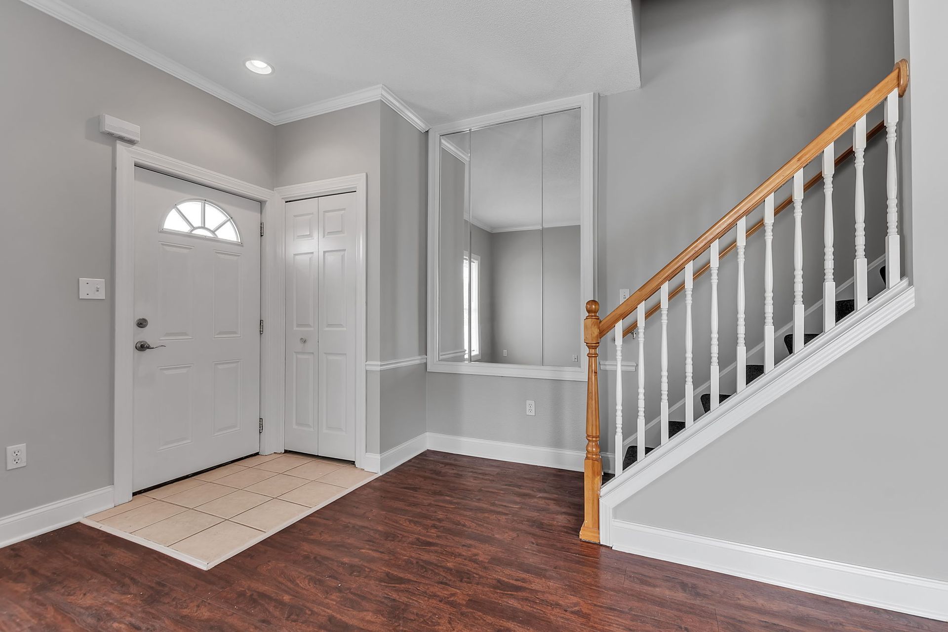 Entryway of townhouse with staircase.
