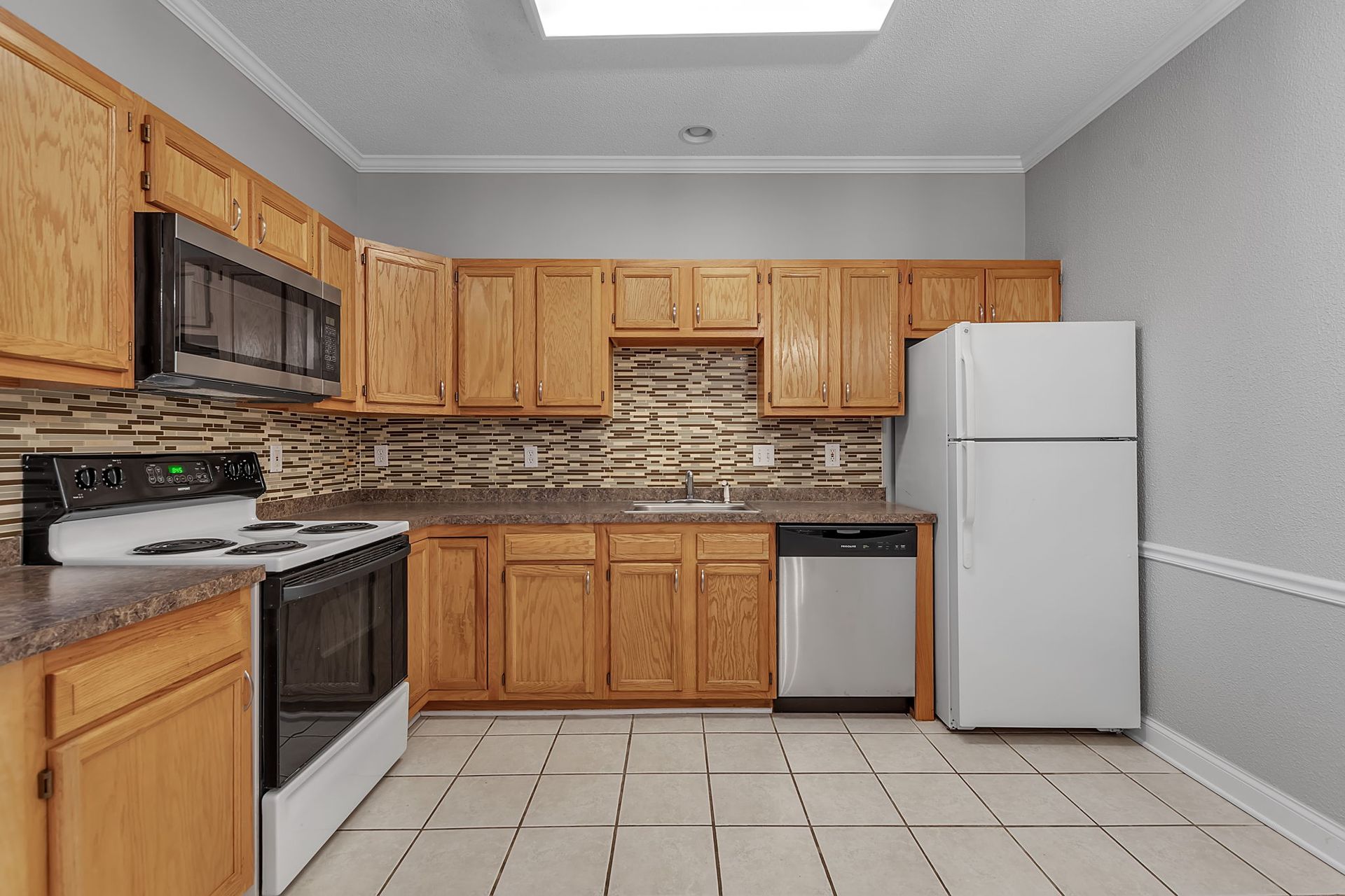 Apartment kitchen with sleek cabinets and countertop workspace