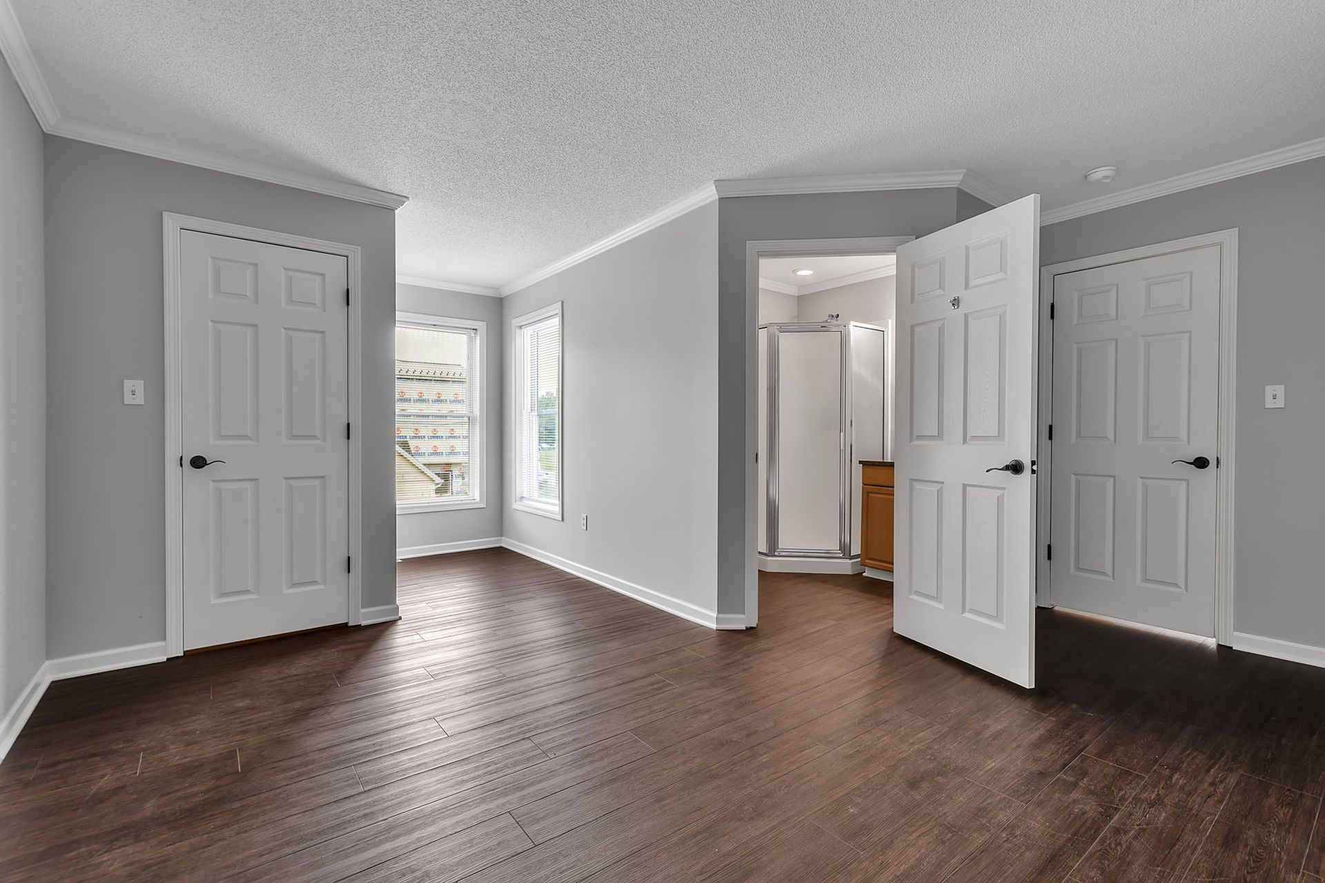 Apartment bedroom with natural light and ceiling fan