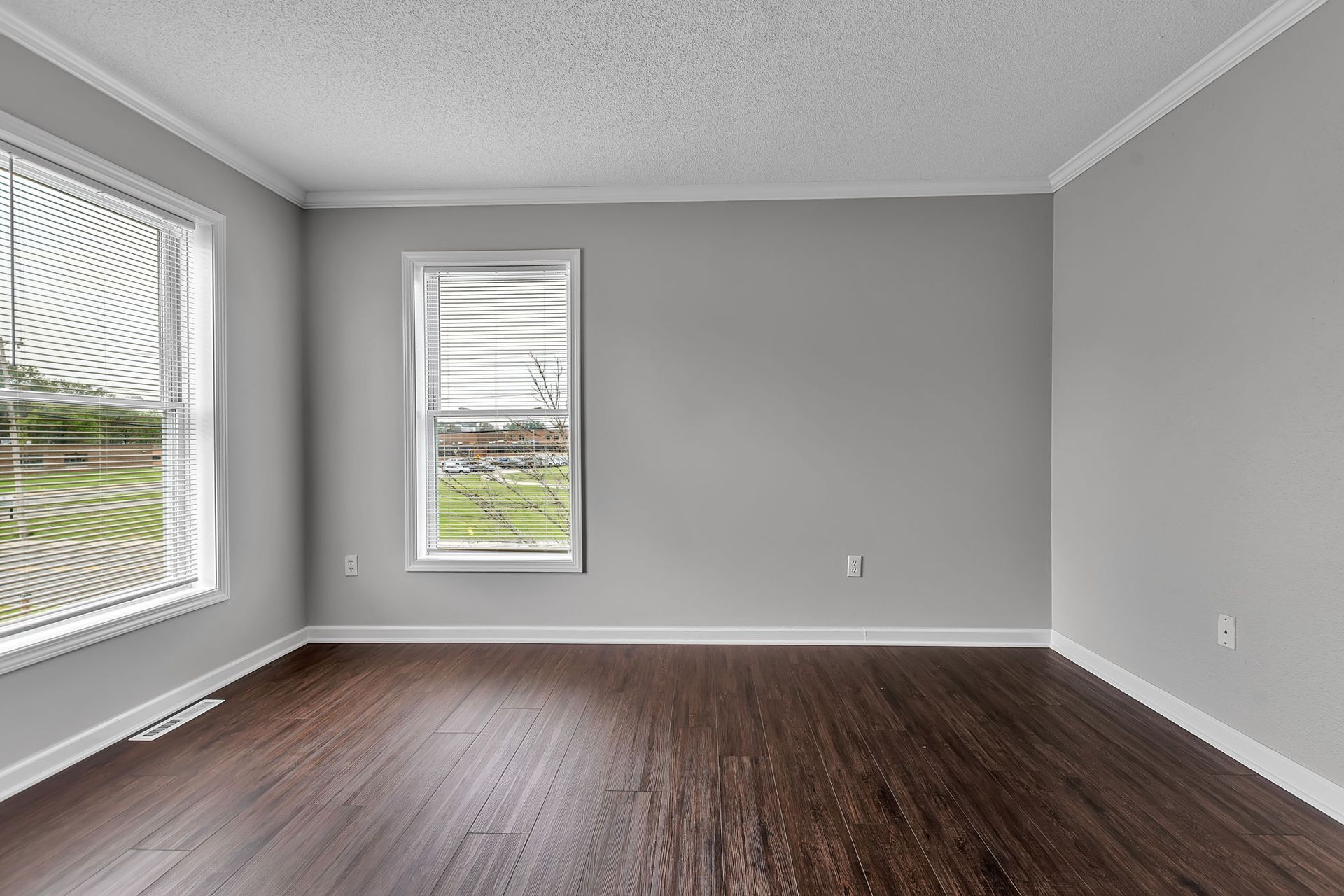 Comfortable bedroom with modern flooring and neutral walls