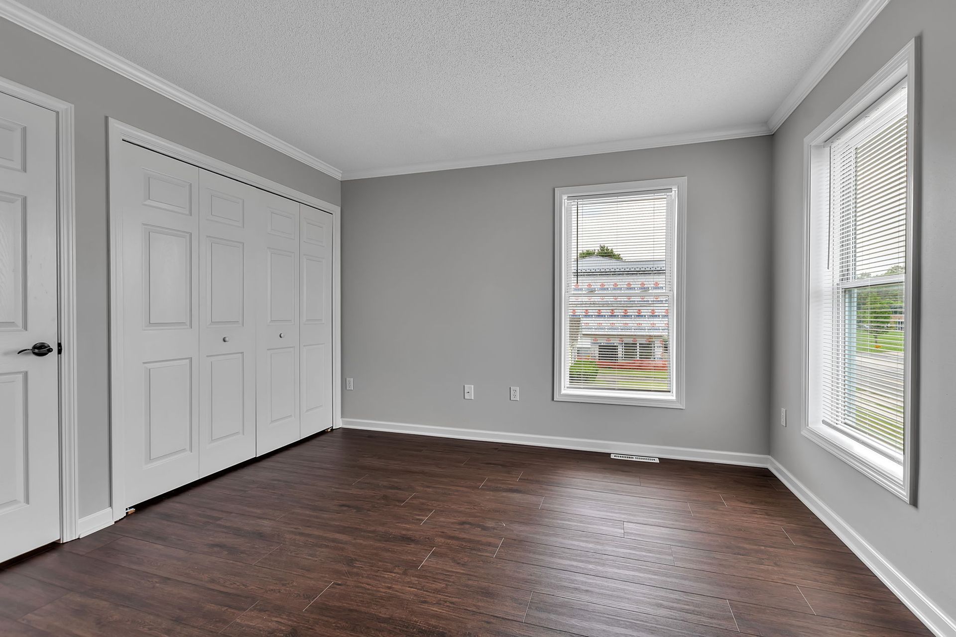 Apartment bedroom with ceiling fan and large closet doors