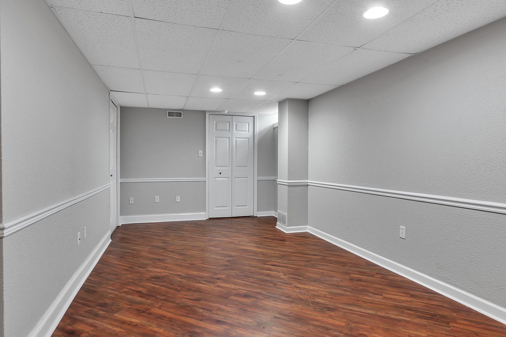 Residential apartment sitting area with updated flooring and wall trim