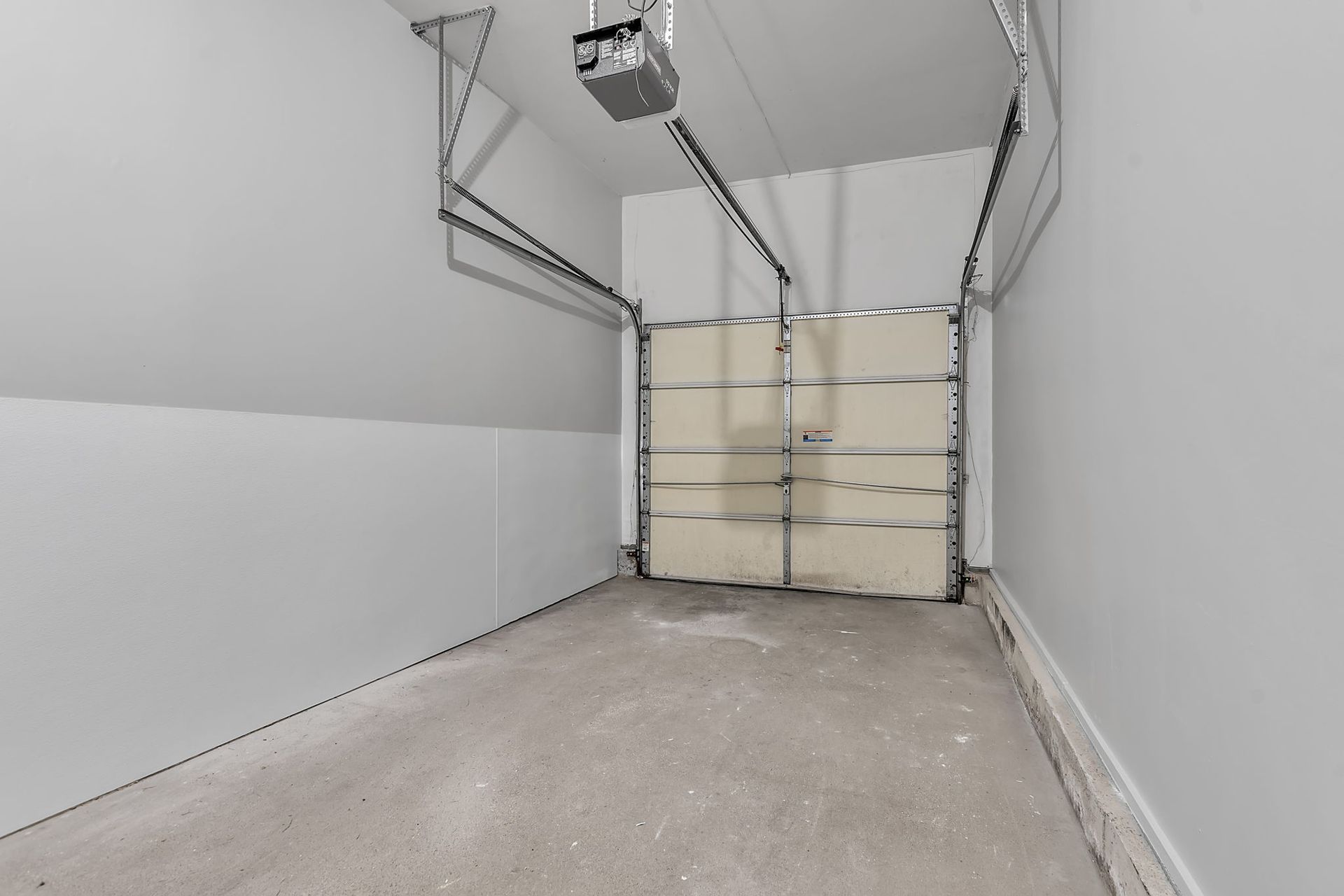 Interior vehicle garage space with concrete flooring