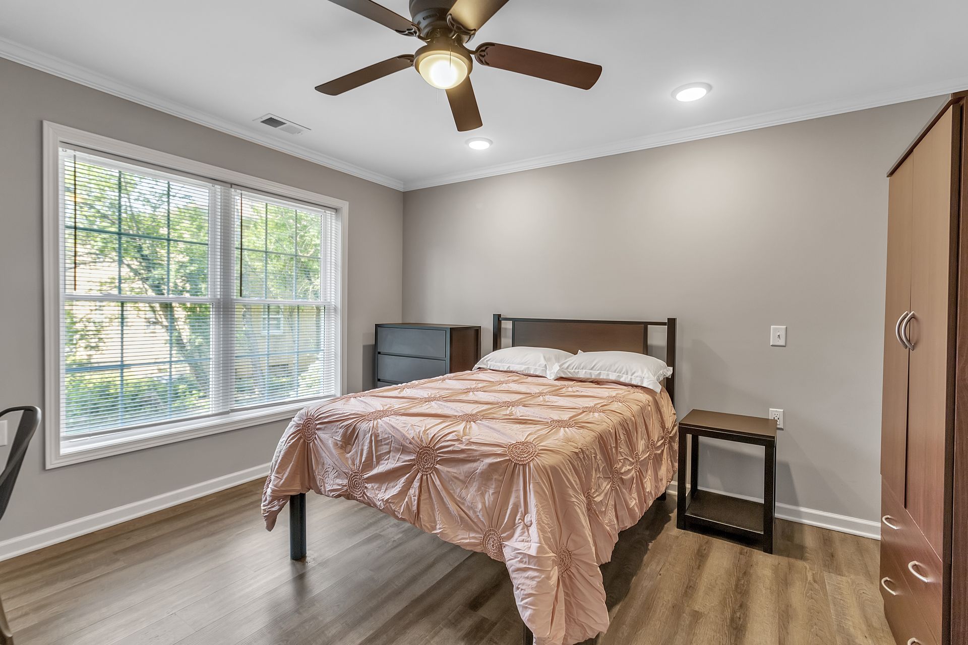 Sleeping area with modern flooring and subtle trim accents