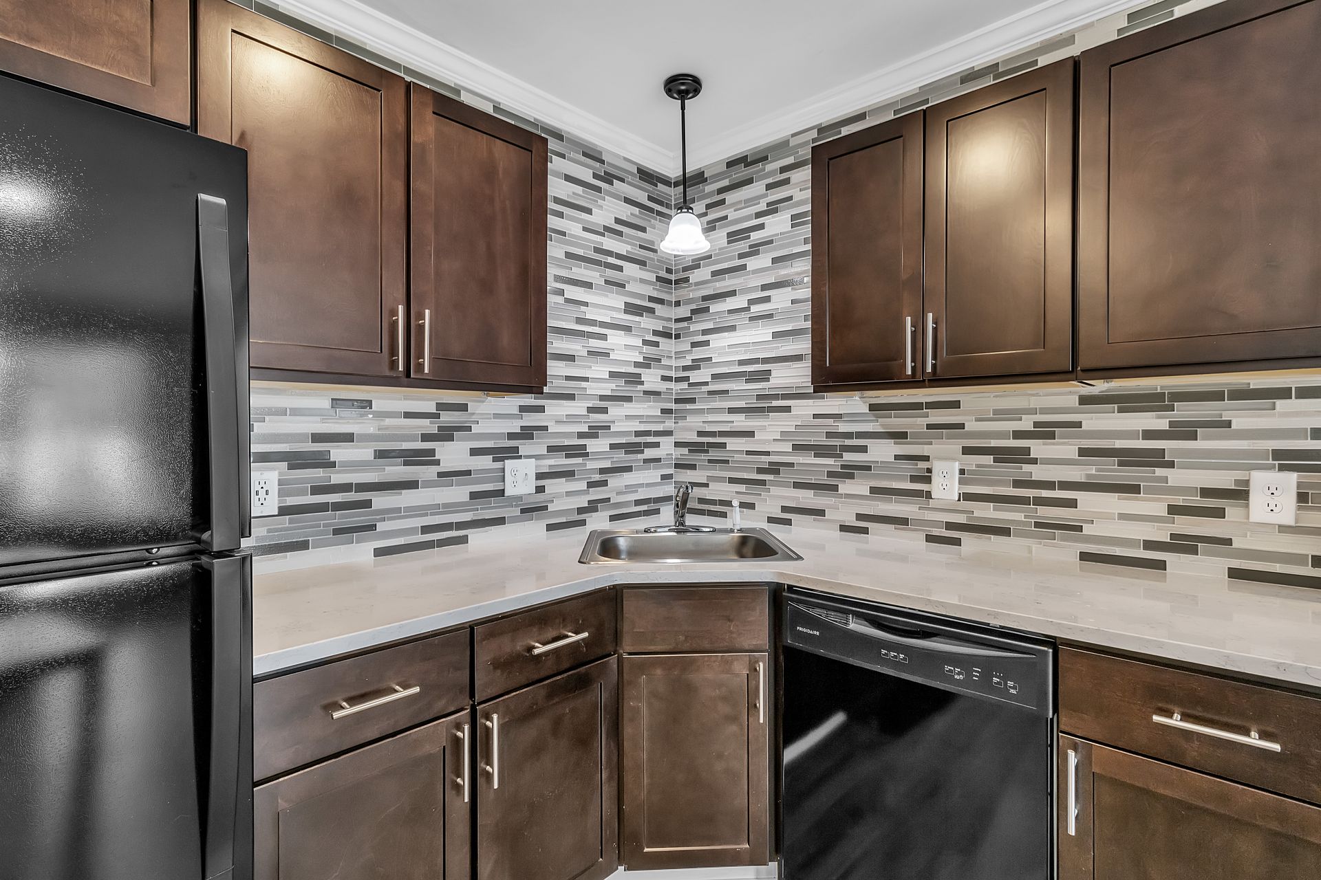 Renovated kitchen with bright lighting and cabinets