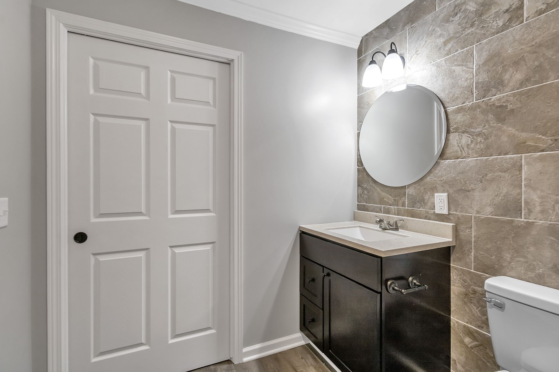 Residential bathroom space with updated plumbing hardware