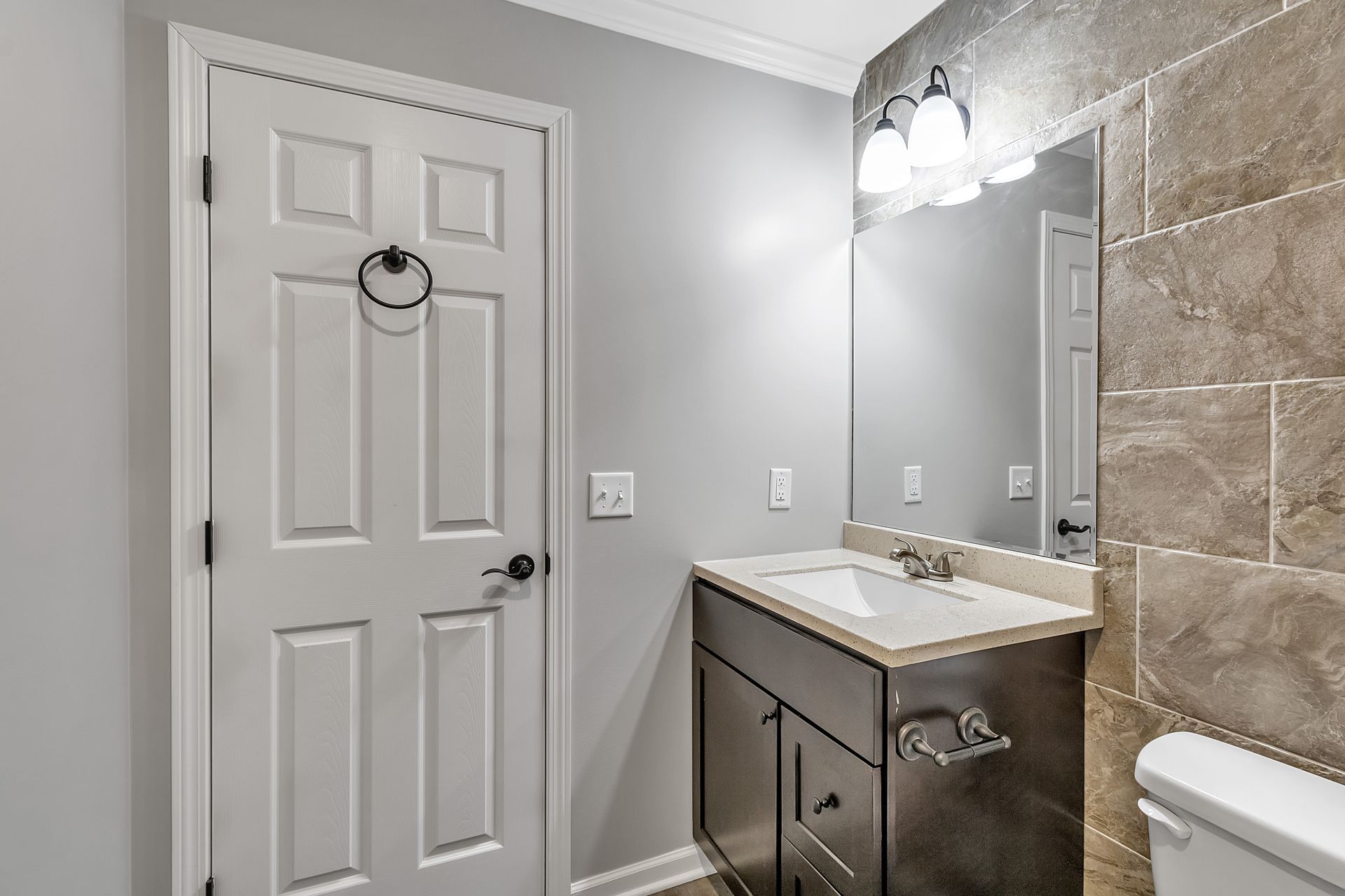 Wash area with contemporary tile installation and mirror